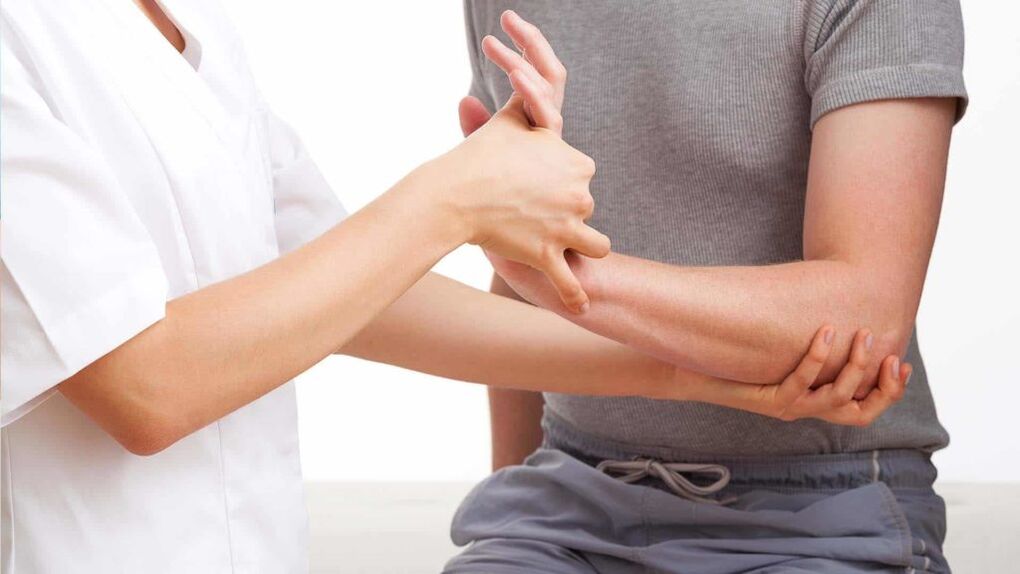 lekár skúma ruku s artritídou